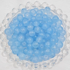 Macro shot of 8mm light blue semi-transparent round glass beads for DIY jewelry making
