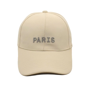Detailed view of the gray PARIS embroidery on a beige cotton canvas baseball cap