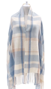 Close-up of thick blue and beige plaid scarf showing soft texture and tassel details