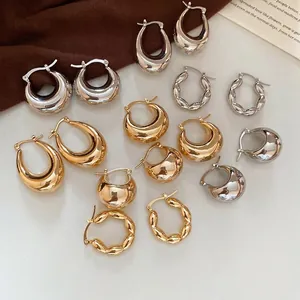 Minimalist C-shaped metallic hoop earrings set in gold and silver finish for women