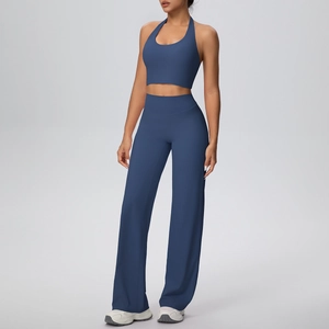 Detail of navy blue halter yoga top and high-waisted wide-leg athletic pants set