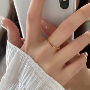 On-finger view of a slim 18k gold-plated ring set with rainbow colorful cubic zirconia