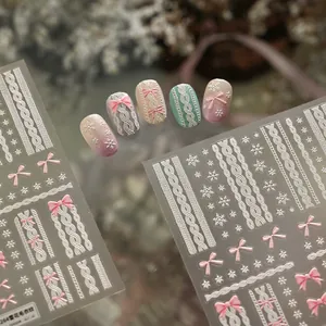 Detailed 5D embossed nail stickers featuring winter snowflakes and pink sweater textures