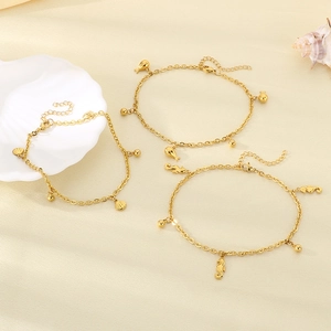 Detailed shot of 18K gold plated anklets with shell, fish, and seahorse charms