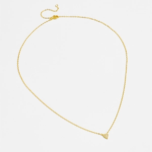 Macro detail of gold S925 silver heart pendant necklace with shimmering zircon stones