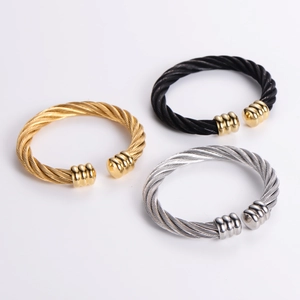 Three men's twisted cable cuff bracelets in gold, silver, and black stainless steel