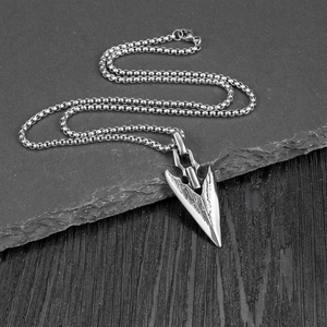 Retro stainless steel arrowhead pendant necklace with beaded chain on stone and wood