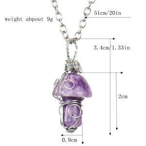 Macro detail of purple crystal mushroom pendant with artistic silver wire wrapping