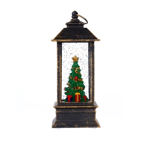 Close-up of bronze Christmas lantern featuring a miniature tree and silver glitter inside