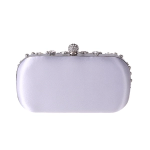 Close-up of light purple satin evening clutch with sparkling rhinestone trim and clasp
