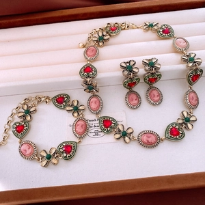 Detail of vintage jewelry set with cameo portrait and heart charms in a wooden box