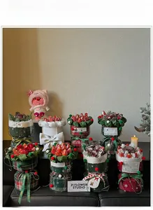 Macro detail of Christmas fruit bouquet set with red plaid fabric and pine branches