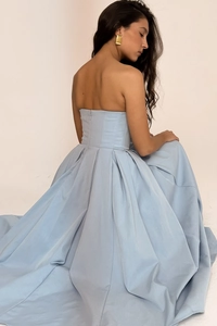 Detail of light blue strapless dress featuring backless design and concealed zipper