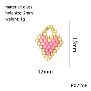 Détail de la perle cœur en verre rose et doré montrant 12mm de large et 15mm de haut