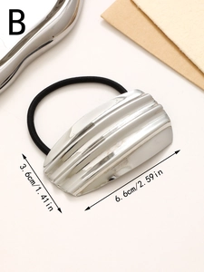 Macro detail of silver geometric hair tie showing vertical texture and dimensions