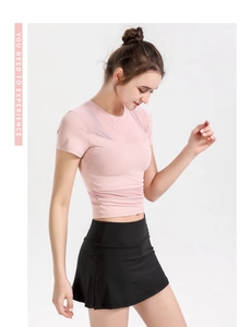 Detail of pink crop top featuring breathable mesh panels and stretchy athletic fabric