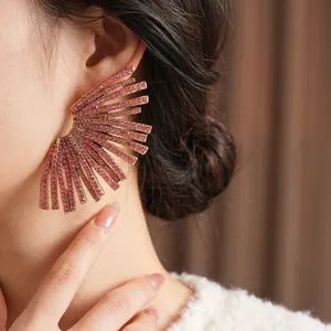 Luxurious gold fan-shaped earrings with purple rhinestones for women shown on model