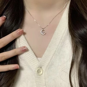 Elegant titanium steel crescent moon necklace with sparkling pendant on female model