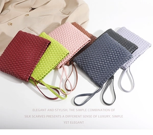 Selection of hand-woven clutch bags in various colors arranged on a blazer