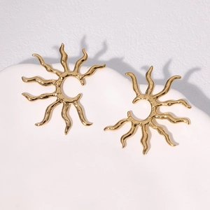 Golden stainless steel sunburst stud earrings with textured metallic finish on white tray