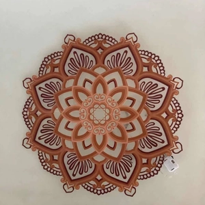 Carved wood Mandala night light with layered lotus patterns in red-brown and brown tones
