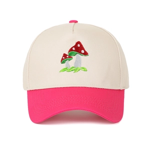 Close-up of mushroom embroidery on a cream and pink two-tone cotton trucker hat