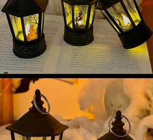 Close-up of Halloween lantern hanging ring and trio of pumpkin lanterns on books