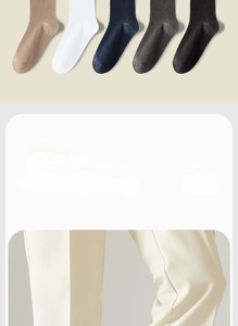 Detail of assorted cotton crew socks in beige, navy, and grey showing ribbed texture