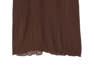 Detailed close-up of brown pleated fabric texture and hem on this midi dress