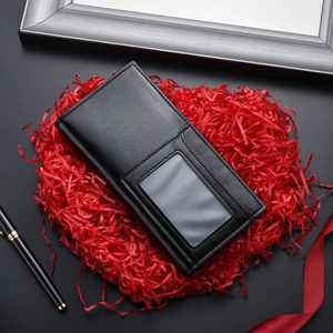 Classic black leather long wallet for men with ID window on a festive red gift background