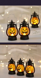 Macro detail of portable Halloween pumpkin lanterns with black handles and warm LED lights