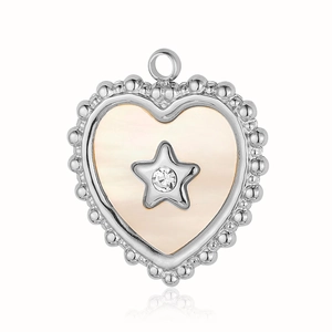 Macro detail of heart-shaped shell pendant with silver star and crystal inlay
