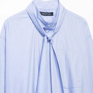 Light blue long-sleeved shirt featuring a stylish bow-tie collar and a single front pocket