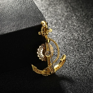 Elegant gold anchor brooch featuring nautical rope design and sparkling cubic zirconia