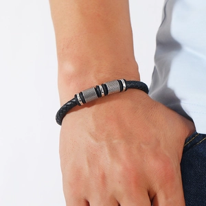 Detail of multi-layer woven black PU leather bracelet with silver magnetic alloy clasp
