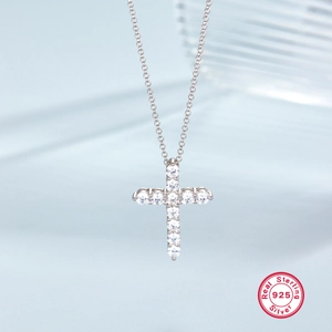 Macro shot of S925 sterling silver cross pendant featuring sparkling zircon stones