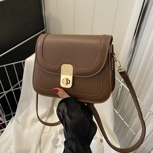 Brown leather crossbody bag with gold twist lock and adjustable strap for women