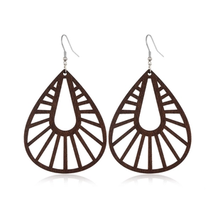 Close-up of vintage brown hollow teardrop wooden earrings with geometric design