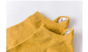 Close-up of yellow cotton ankle sock featuring cute animal embroidery on the heel