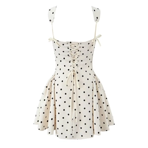 White polka dot mini dress featuring an open back with elegant crisscross tie-up lacing