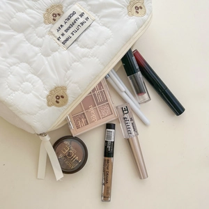 Quilted floral makeup bag with bear embroidery and zipper closure for storage