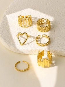 Close-up of 6-piece 18k gold-plated ring set featuring heart and chain textures