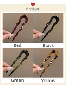 Close-up of four acrylic U-shaped hairpins in red, black, green, and tortoiseshell colors
