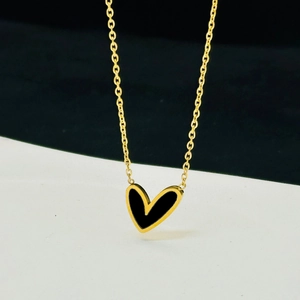 Detailed close-up of a minimalist gold O-chain necklace with a black heart pendant