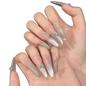 Long stiletto press-on nails with silver-grey cat eye gradient and sparkly rhinestones