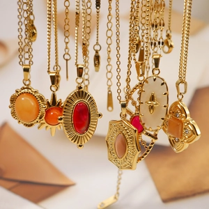 Macro shot of 18K gold-plated bohemian pendants with colorful stones and sunburst patterns