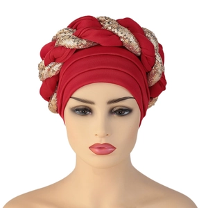 Detailed view of the red headwrap with intricate gold sequin braided craftsmanship