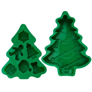 Detail of green silicone Christmas molds with snowflake, gingerbread man and tree shapes