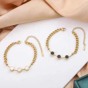 Elegant gold titanium steel bracelet set featuring white shell and black circular charms