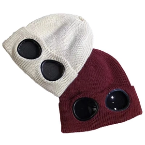 Winter knitted beanie hats with integrated goggles in cream and wine red colors